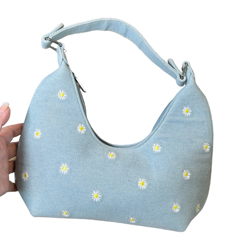 Skinny Dip of London light blue denim shoulder bag with daisies.